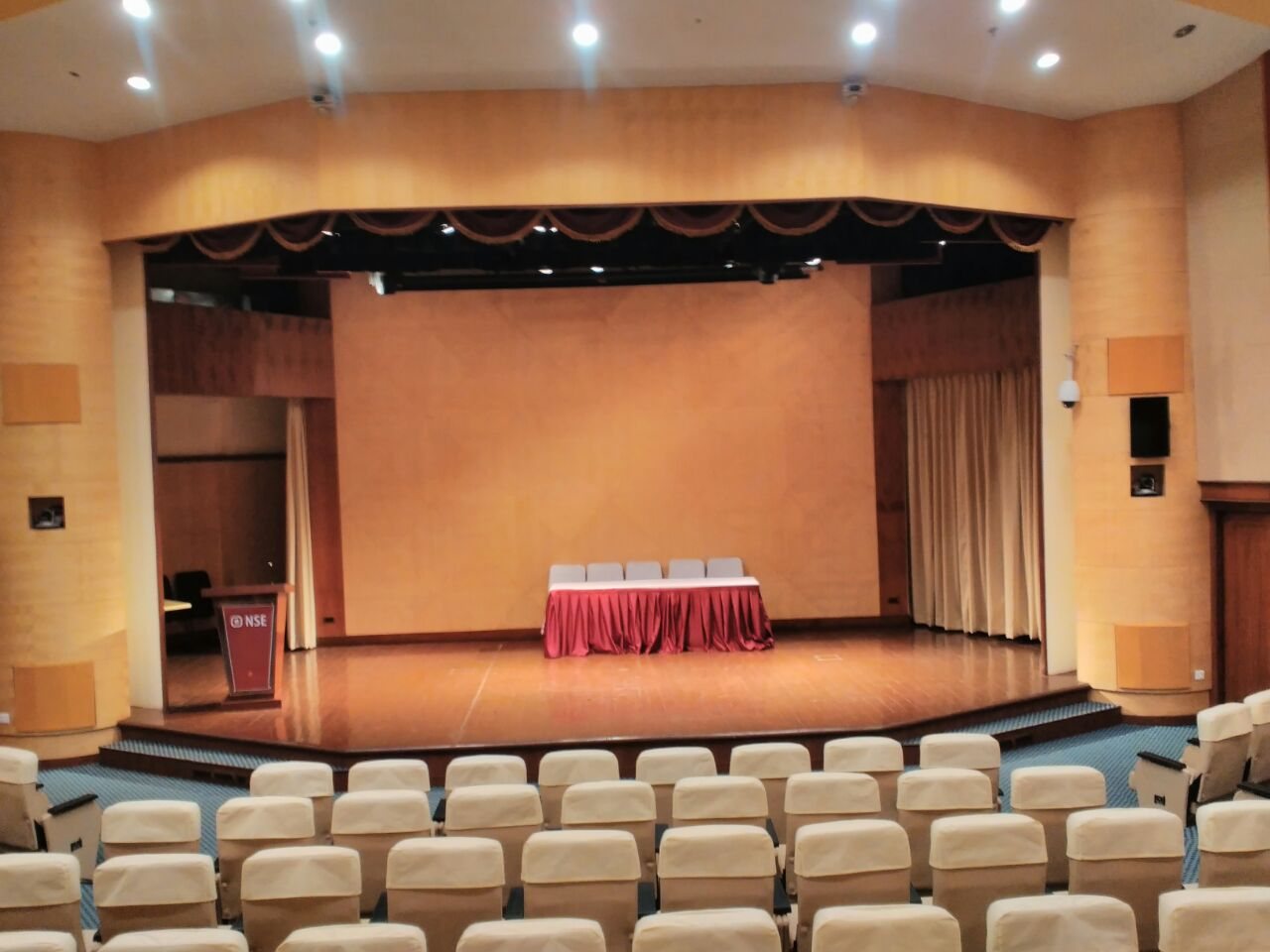 Auditorium completed by PROVAL: tiered seating facing a timber-lined stage